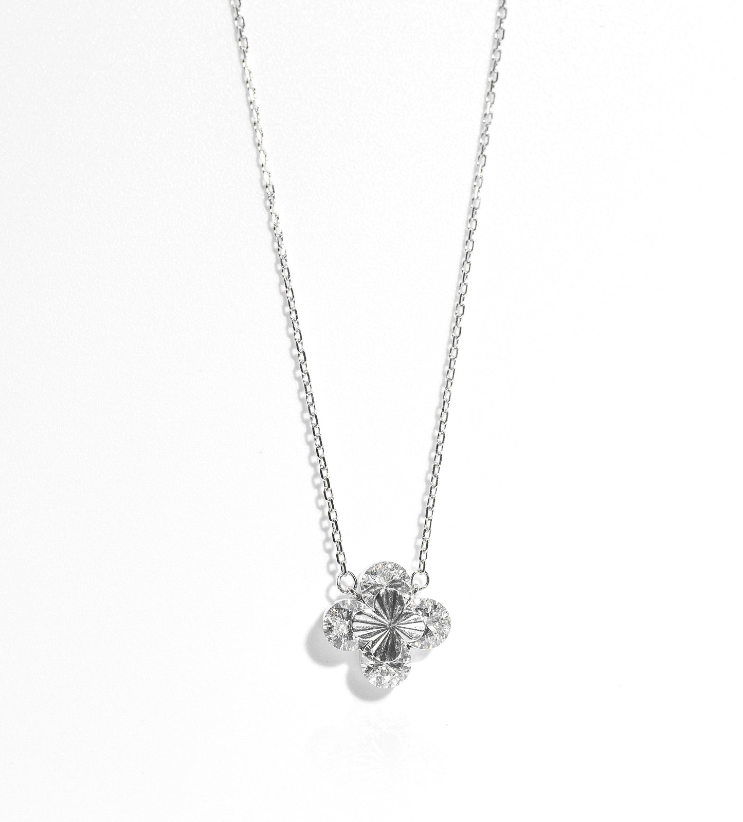 Silver necklace with a floral pendant on a white background