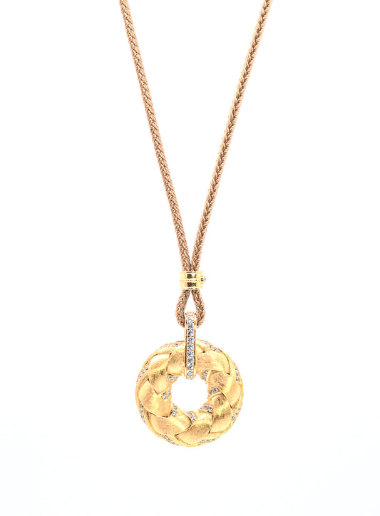 Gold color necklace with a wreath pendant on a white background