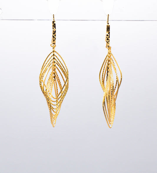 Gold leaf-shaped earrings on a white background
