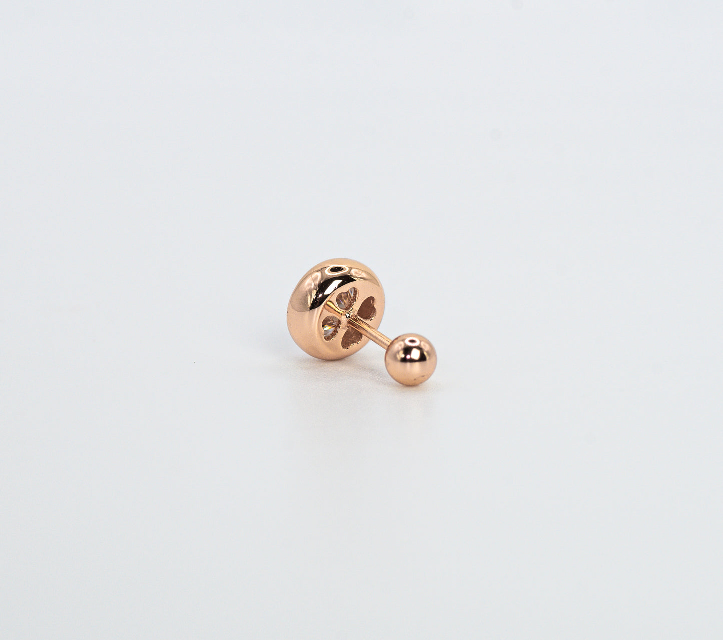 Rose gold color earring on a light gray background