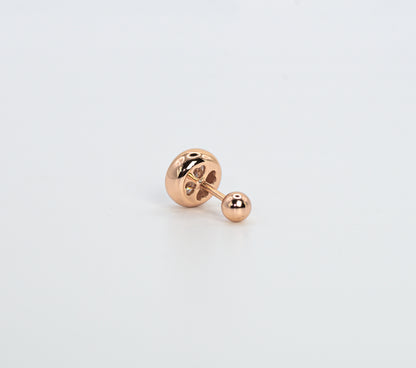 Rose gold color earring on a light gray background