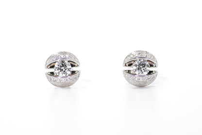 Pair of silver earrings with clear gemstones on a white background