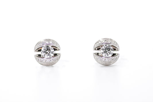 Pair of silver earrings with clear gemstones on a white background