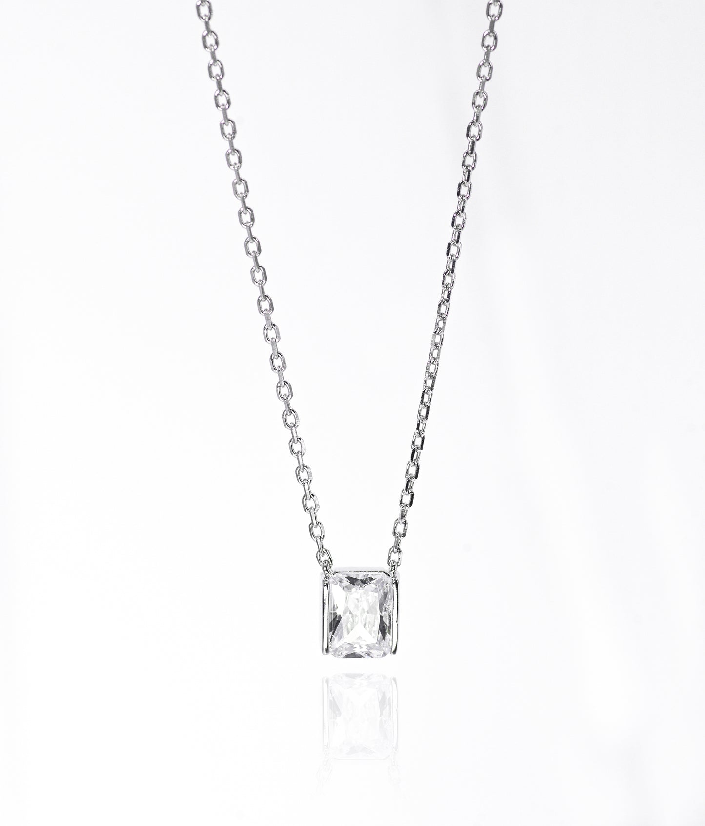 Silver necklace with a square-cut pendant on a white background