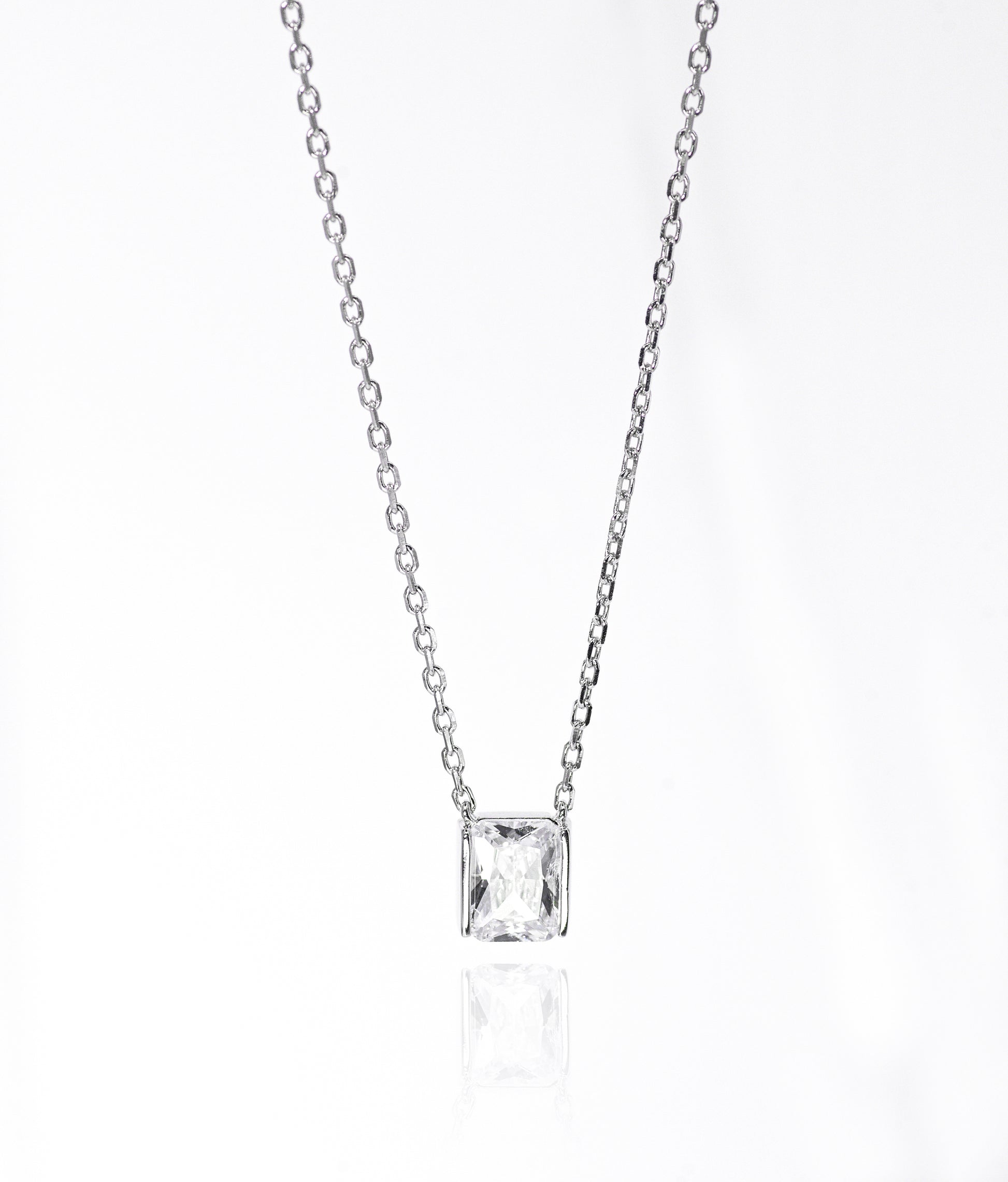 Silver necklace with a square-cut pendant on a white background