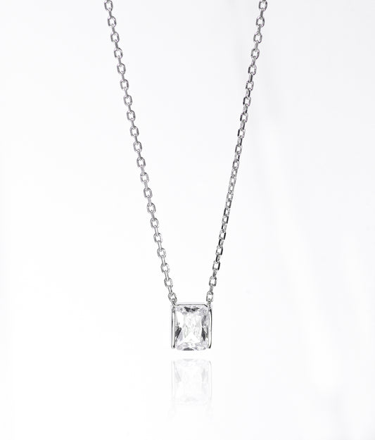 Silver necklace with a square-cut pendant on a white background