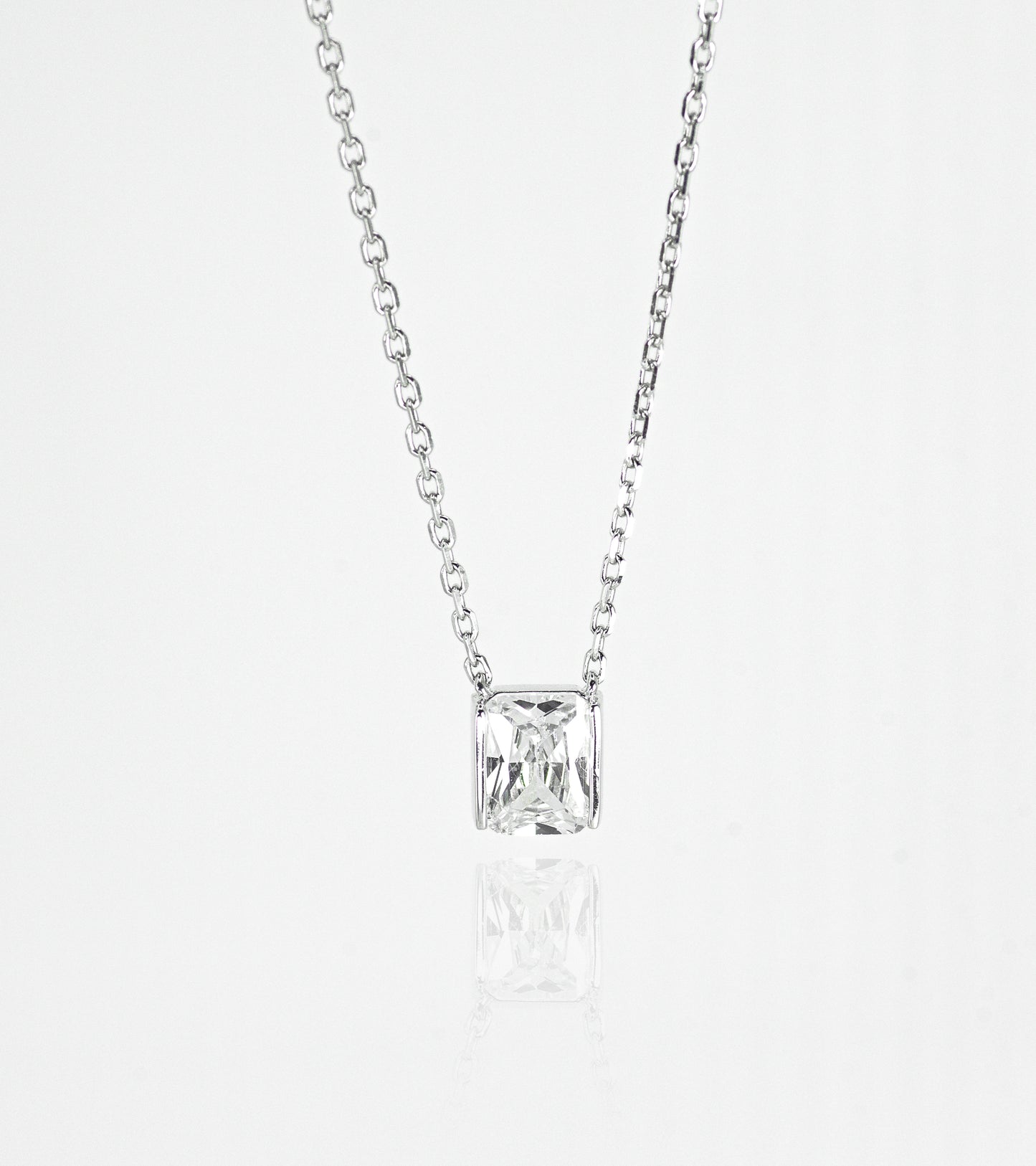 Silver necklace with a square-cut pendant on a white background