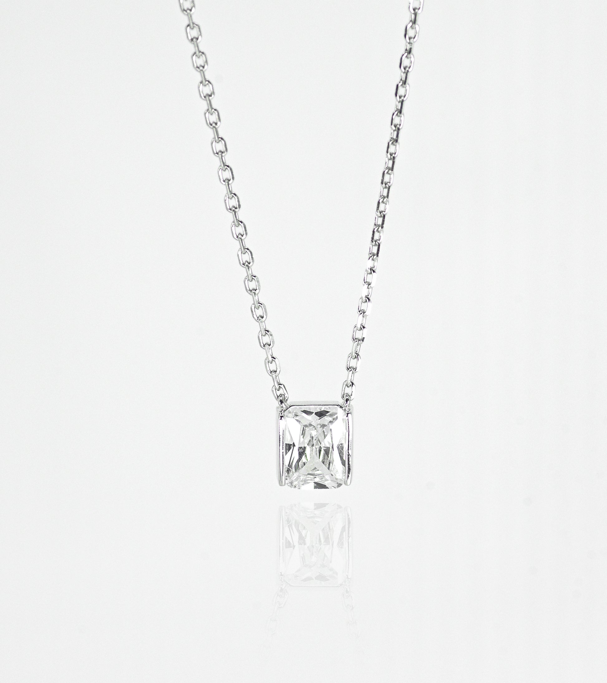 Silver necklace with a square-cut pendant on a white background