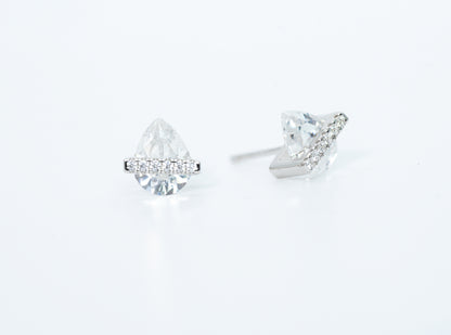 Pair of diamond stud earrings on a light gray background