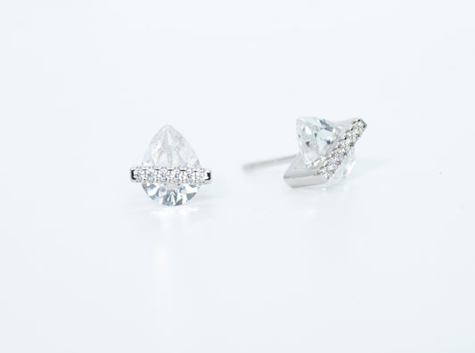 Pair of diamond stud earrings on a light gray background