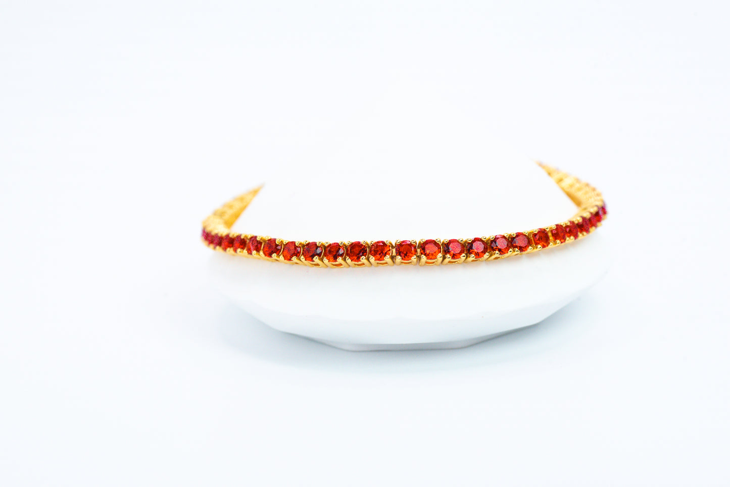 Gold headband with red stones on a white background
