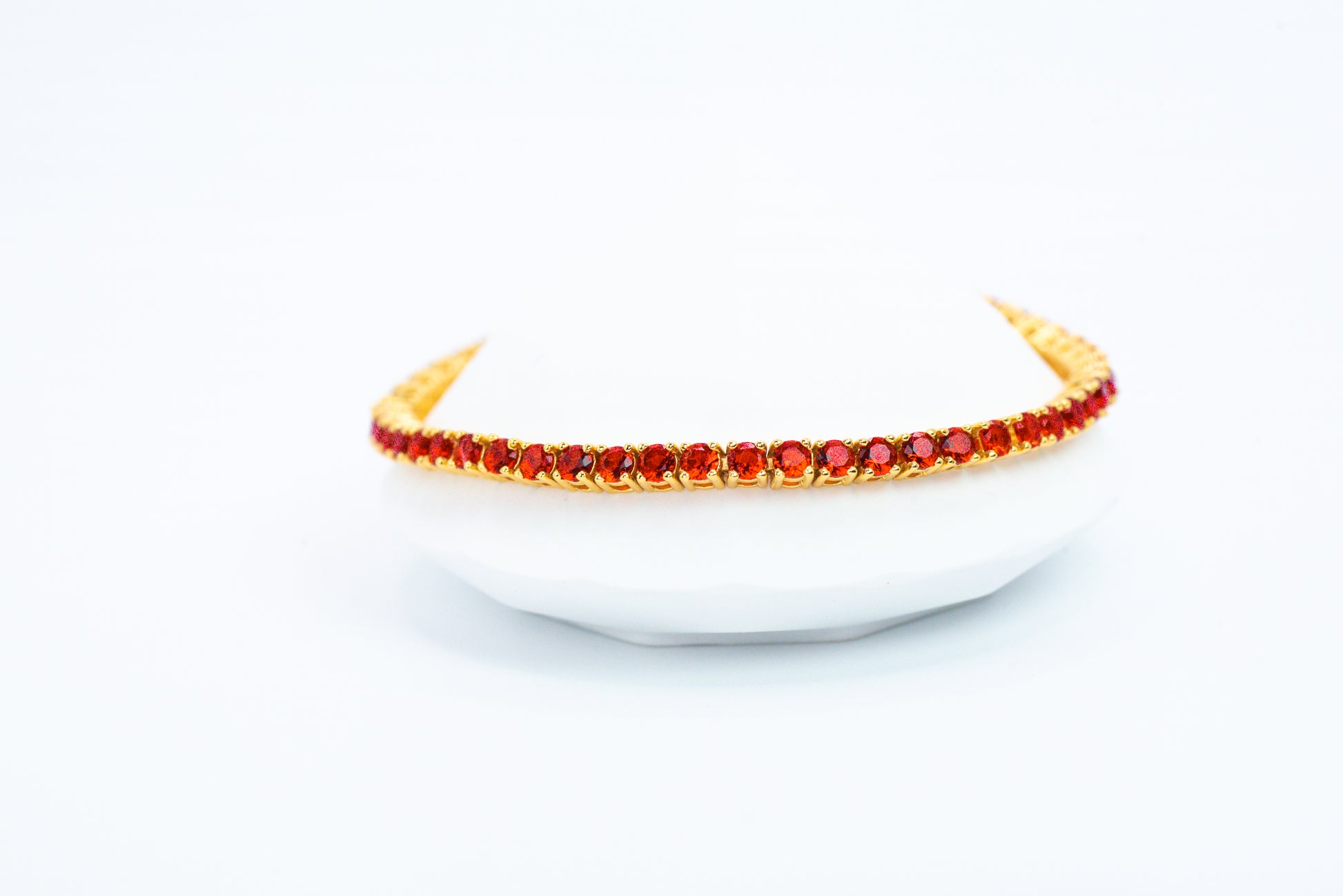 Gold headband with red stones on a white background