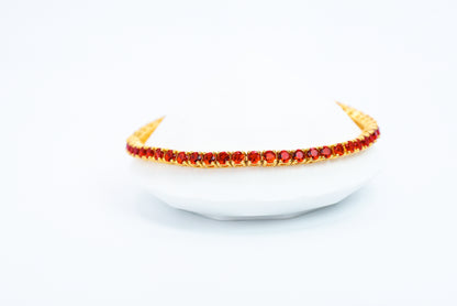 Gold headband with red stones on a white background