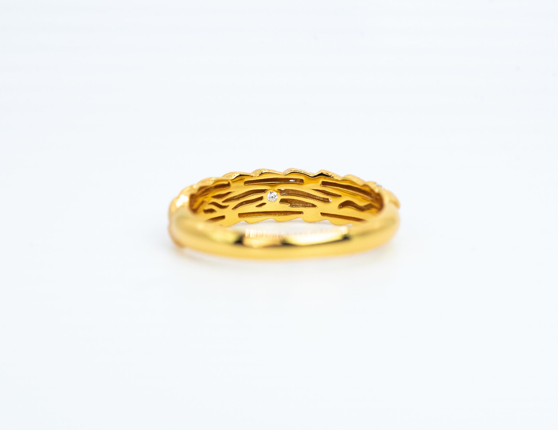 Gold ring with a diamond on a white background