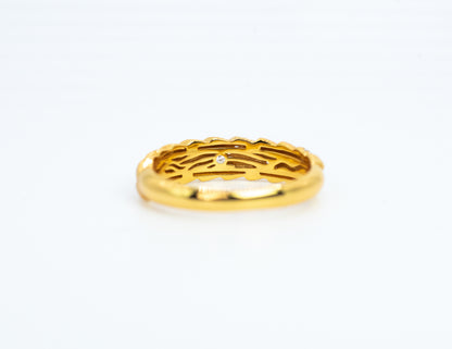Gold ring with a diamond on a white background