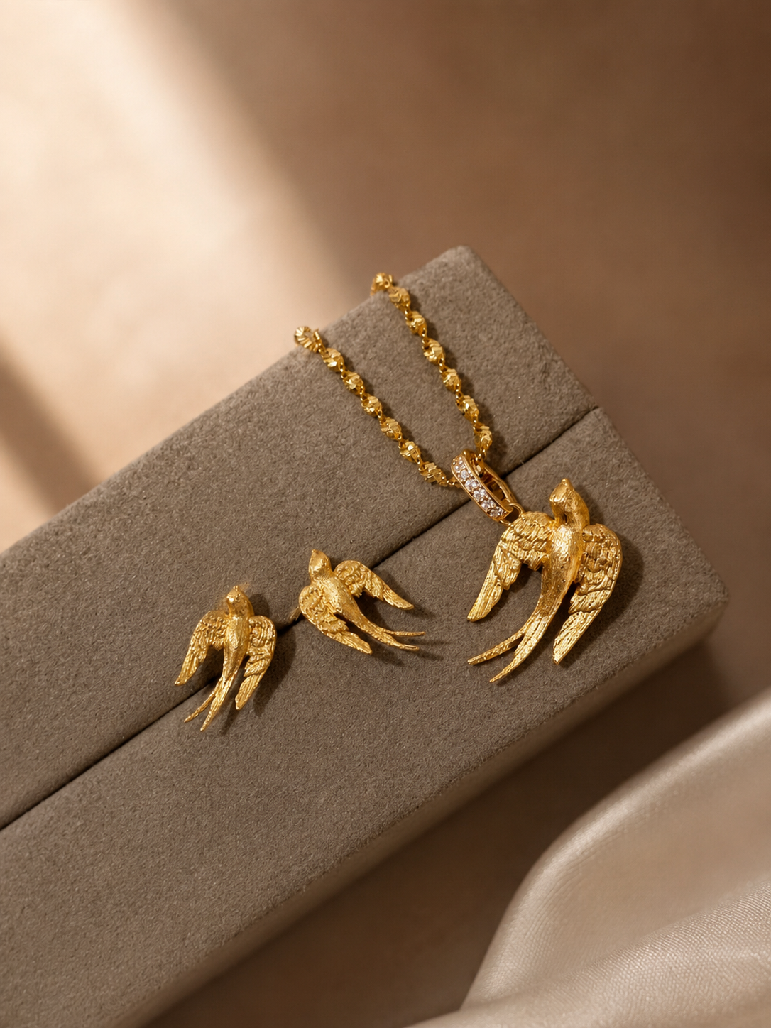 Lunelle Atelier brushed swallow stud earrings featuring sleek metal design and small swallow bird shape on a plain background.