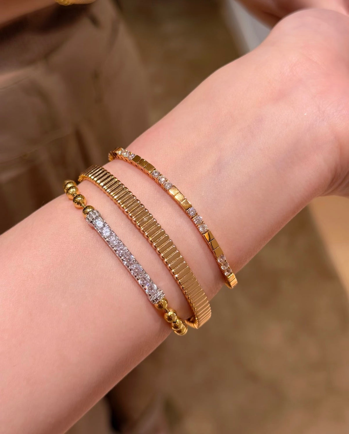 Shiny high-polish ribbed bangle bracelet by Lunelle Atelier, featuring a sleek, textured design on a smooth metal surface.