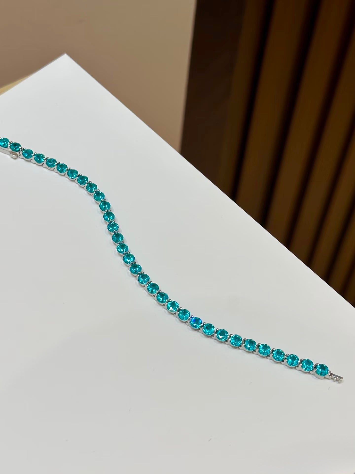 Lunelle Atelier floating round-cut tennis bracelet with sparkling gemstones, elegant jewelry piece in close-up.