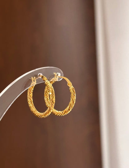 Textured multi-strand twist hoop earrings by Lunelle Atelier, showcasing their intricate design and shiny metal finish.