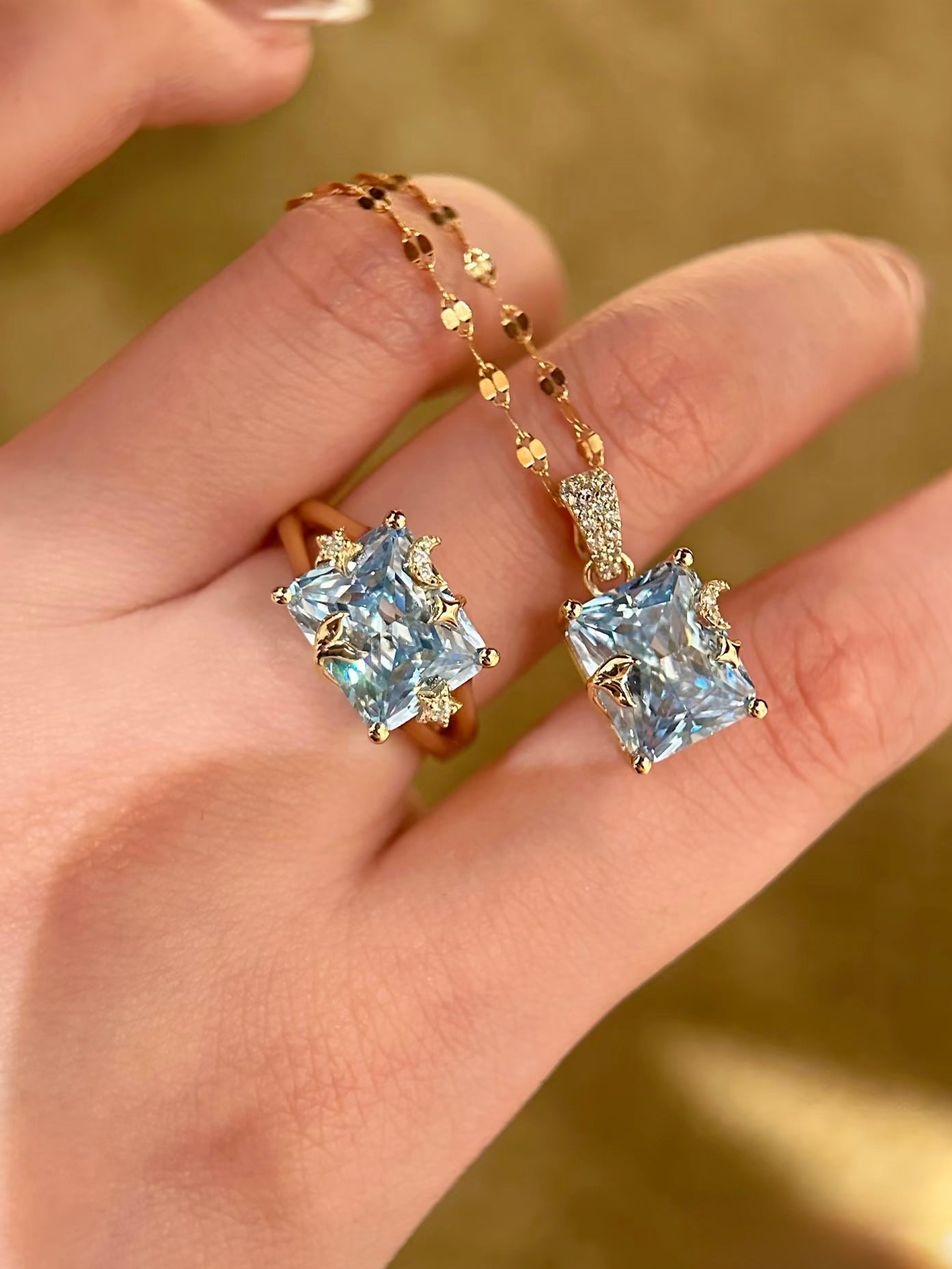 Lunelle Atelier Mermaid Moon emerald-cut blue crystal pendant necklace with convertible design, showcasing a shimmering blue gemstone.