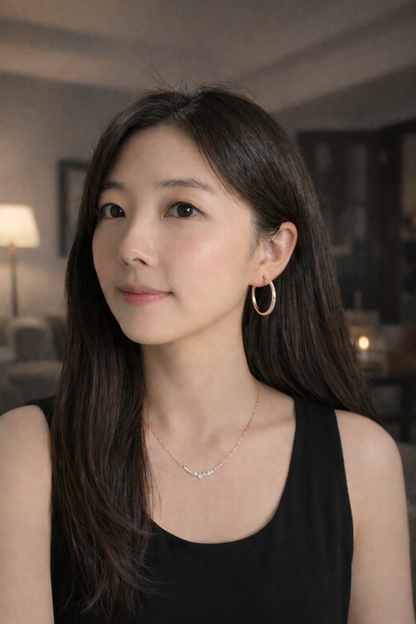 Woman wearing a black top with a blurred indoor background