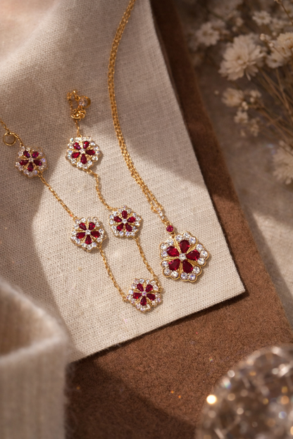 Gold necklace with floral pendants on a textured surface