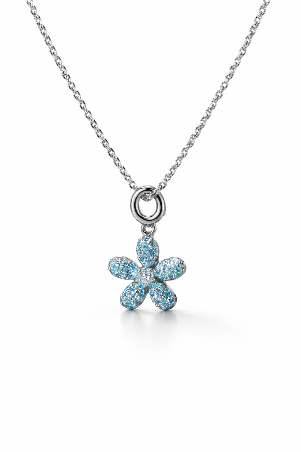 Flower-shaped pendant with blue stones on a chain against a white background