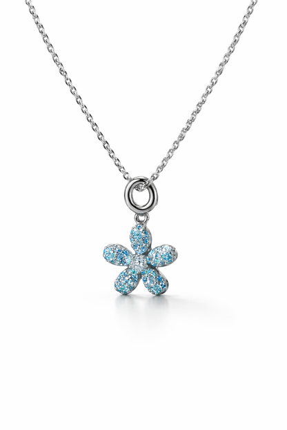 Flower-shaped pendant with blue stones on a chain against a white background