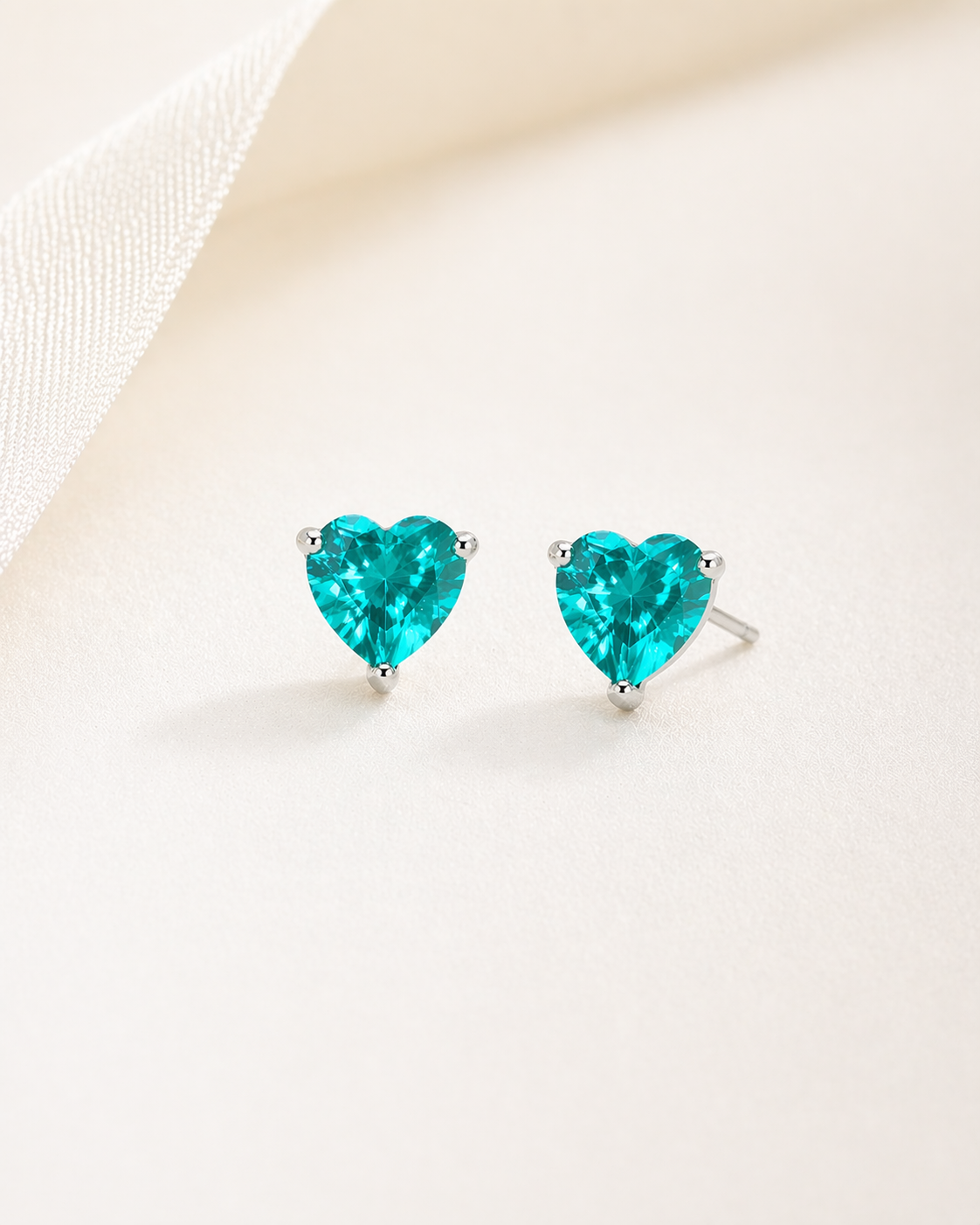 Heart-shaped turquoise earrings on a light background