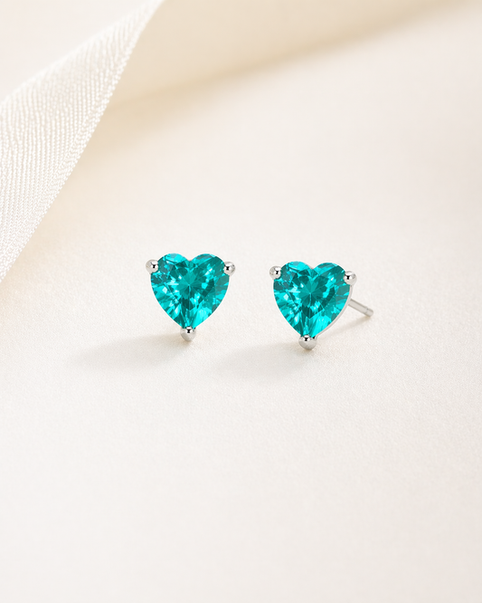 Heart-shaped turquoise earrings on a light background