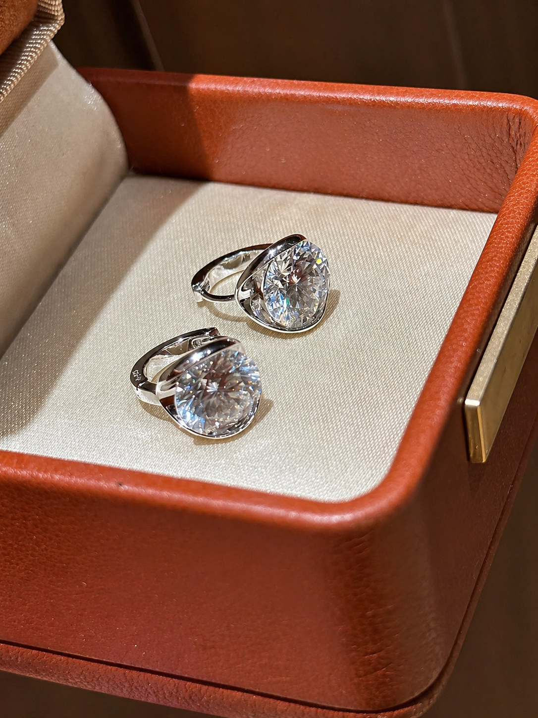 Pair of diamond rings in a brown jewelry box