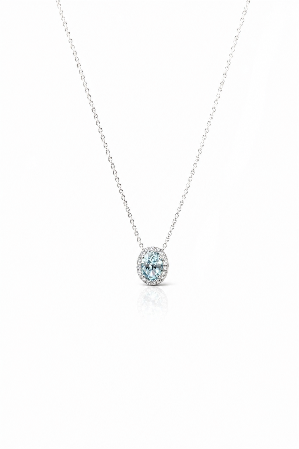 Silver necklace with a round blue gemstone pendant on a white background