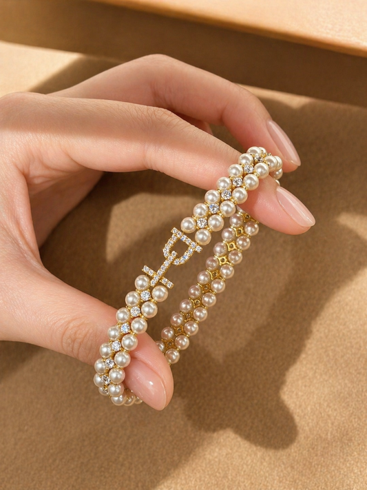 Hand holding a pearl headband against a beige background