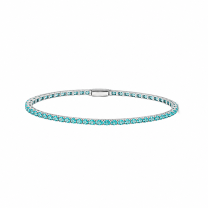 Petite Lab-Grown Paraiba tennis bracelet by Lunelle Atelier featuring vibrant blue-green gemstones and a delicate silver chain.