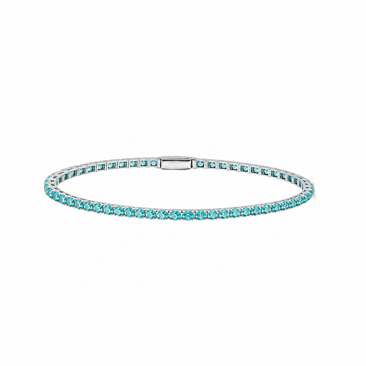 Petite Lab-Grown Paraiba tennis bracelet by Lunelle Atelier featuring vibrant blue-green gemstones and a delicate silver chain.