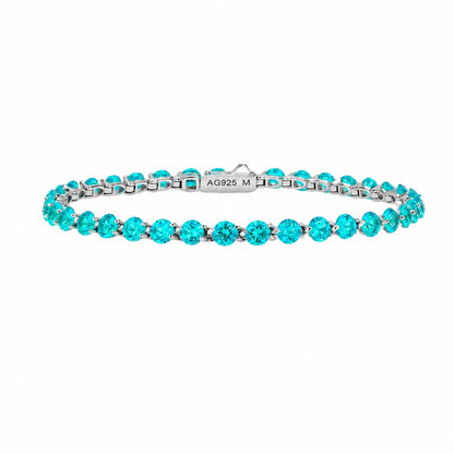 Floating lab-grown Paraiba tennis bracelet by Lunelle Atelier featuring vibrant blue-green gemstones and elegant silver setting.