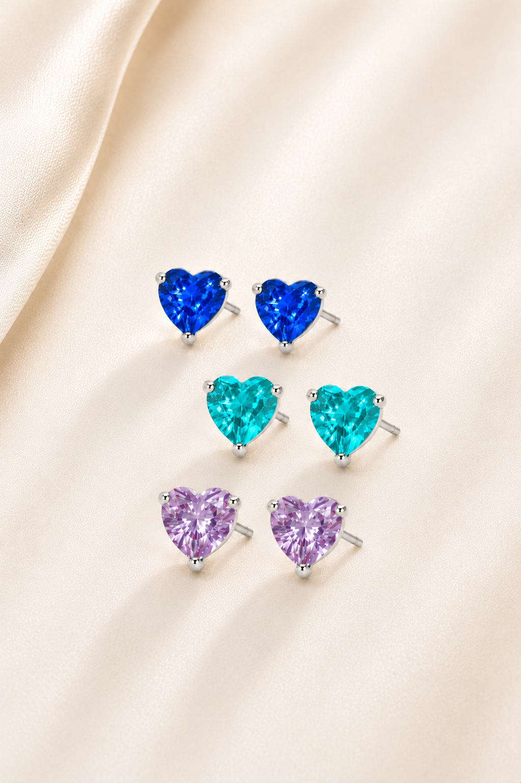 Lunelle Atelier Heart Glow gemstone stud earrings with pink stones and silver settings, close-up view of elegant jewelry.