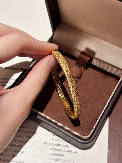 Lunelle Atelier oval hinged baguette bracelet with sleek gold design, showcasing a modern, elegant jewelry piece.