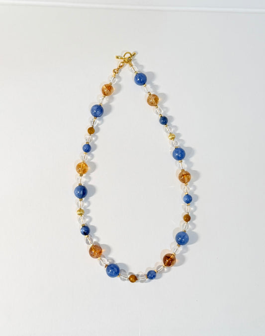 Necklace with blue and gold beads on a white background