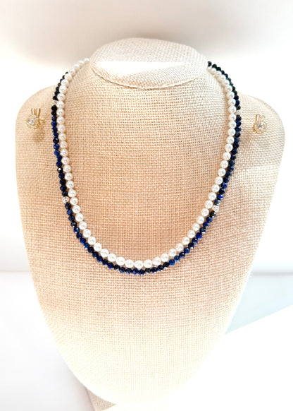 Pearl and blue beaded necklace on a mannequin bust with matching earrings.