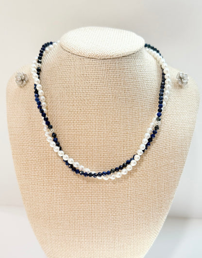 Necklace with blue and white beads on a beige bust