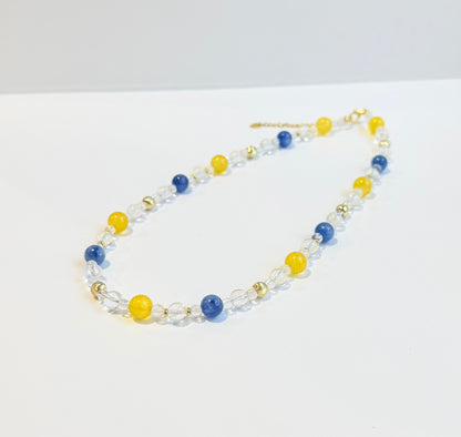 Necklace with blue and yellow beads on a white background
