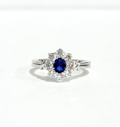 Silver ring with a blue gemstone on a white background