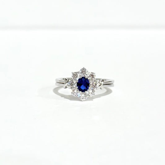 Silver ring with a blue gemstone on a white background