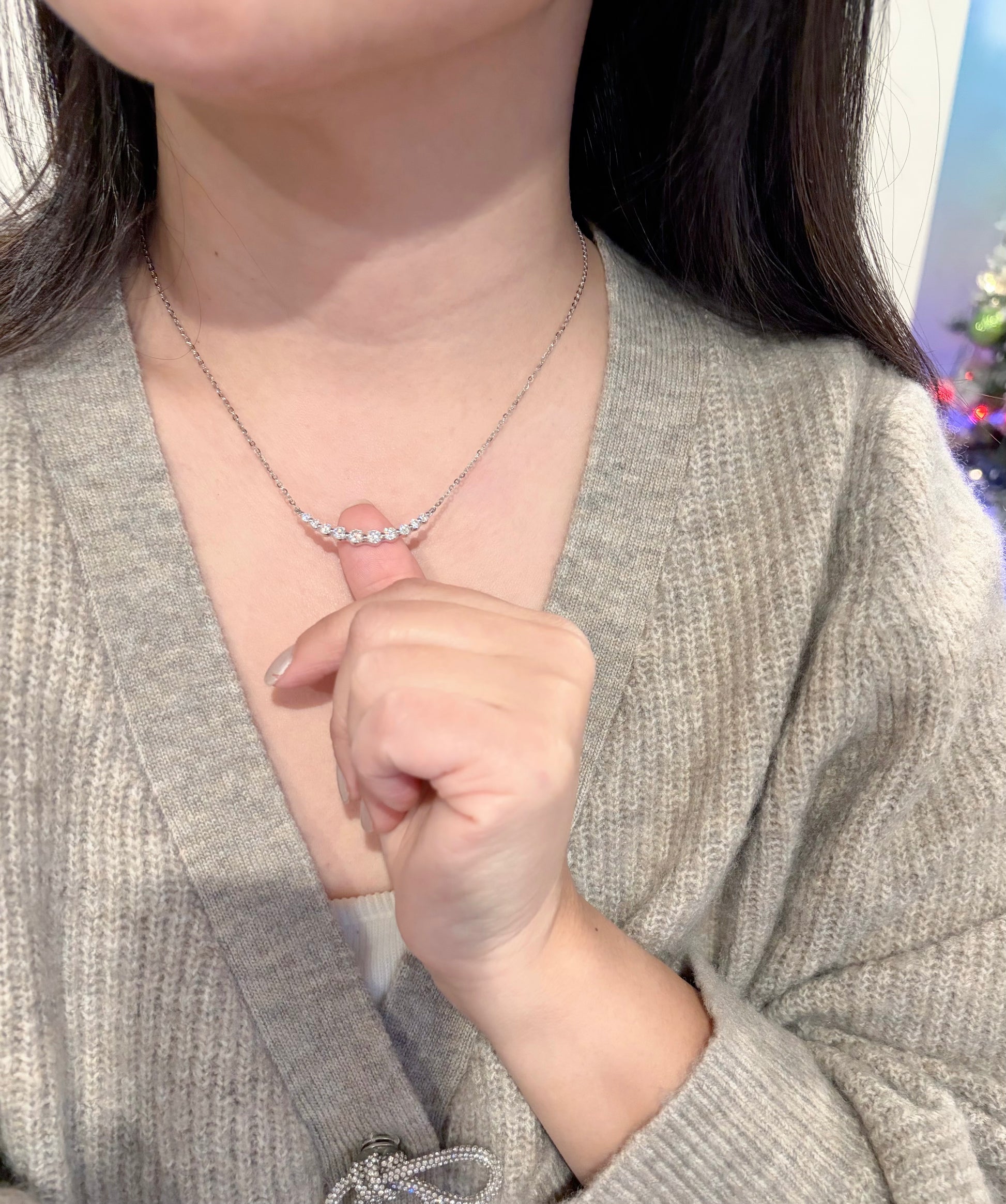 Person wearing a necklace with a blurred background