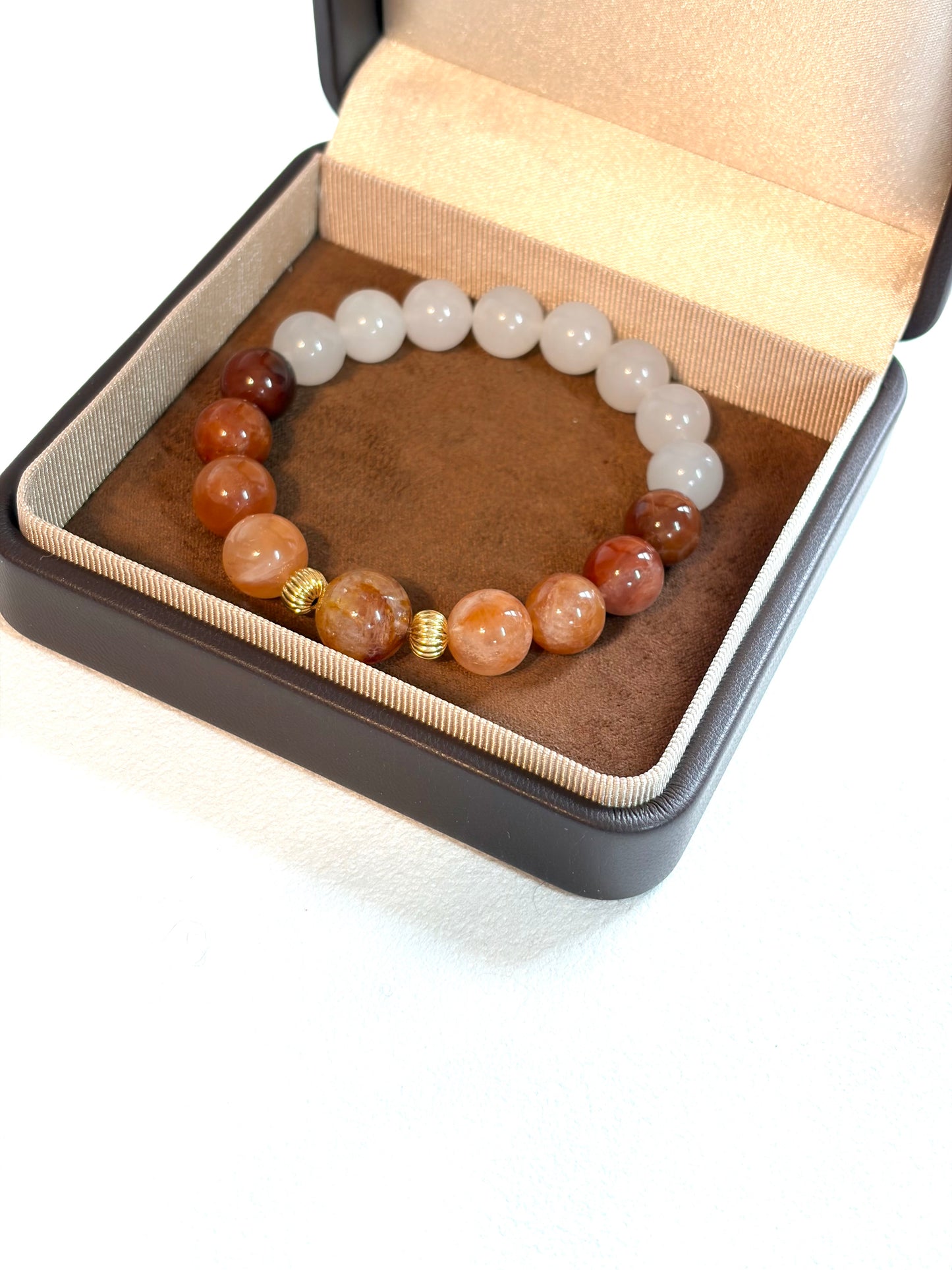 Beaded bracelet with multicolored beads in a jewelry box on a white background