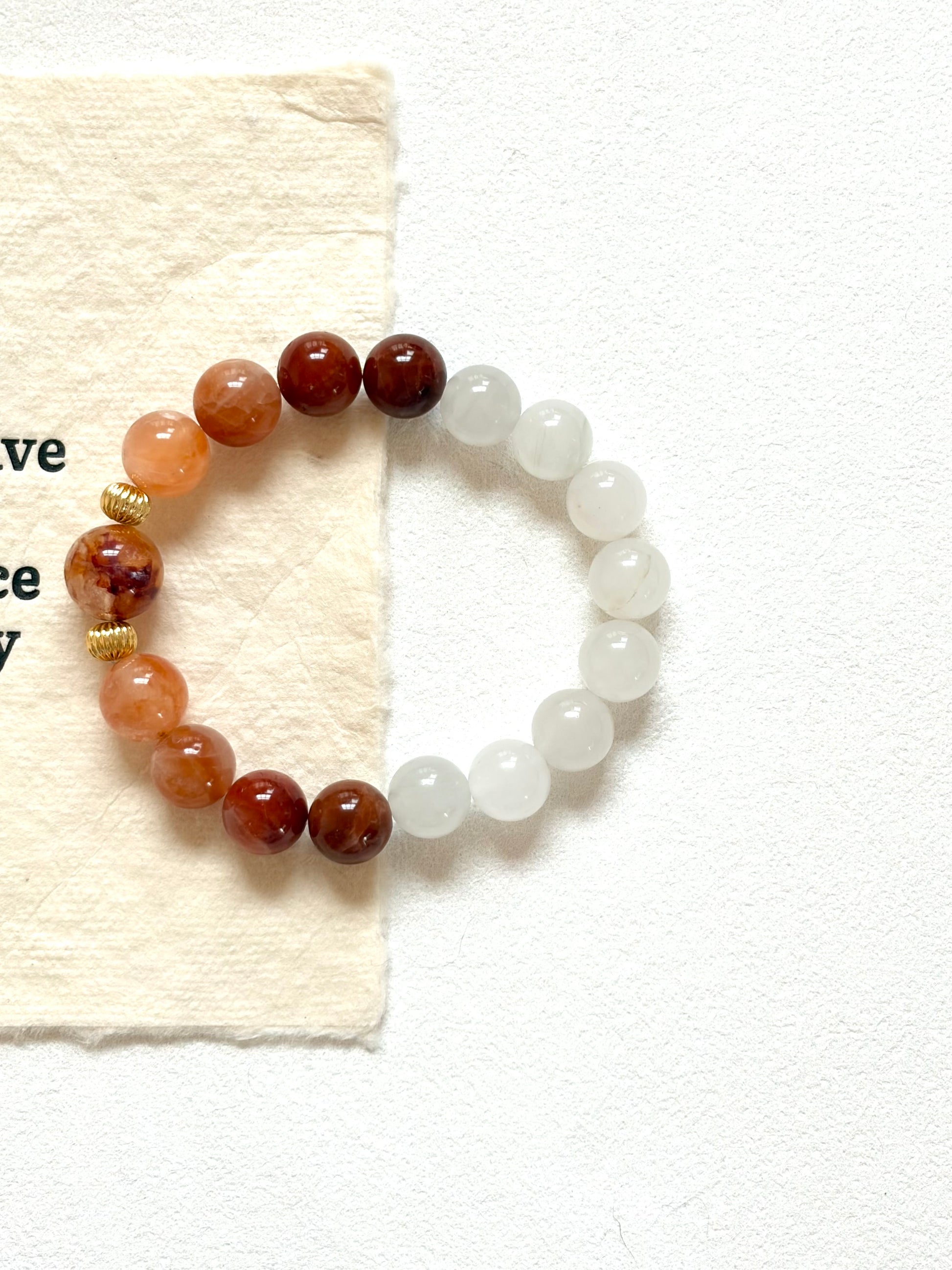 Beaded bracelet with brown and white beads on a white background