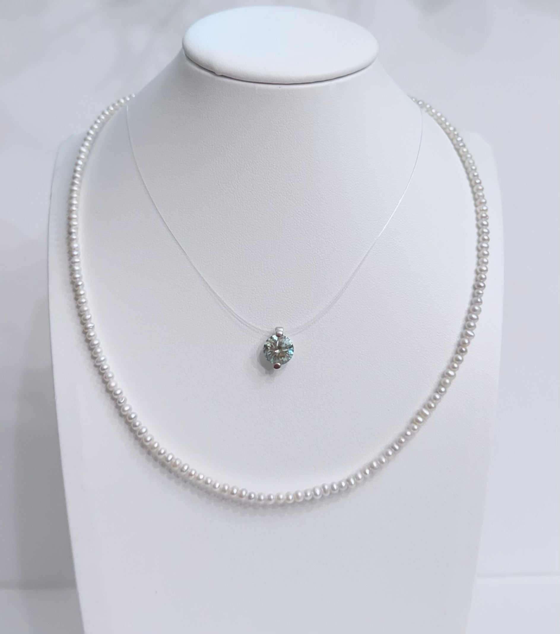 Lunelle by Heart and Hand mini freshwater pearl necklace with a delicate string of lustrous pearls on a white background.