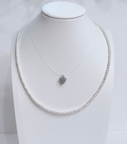 Lunelle by Heart and Hand mini freshwater pearl necklace with a delicate string of lustrous pearls on a white background.