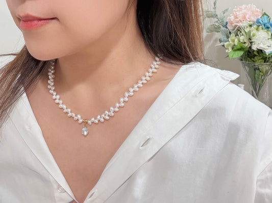 Woman wearing a pearl necklace with a blurred background